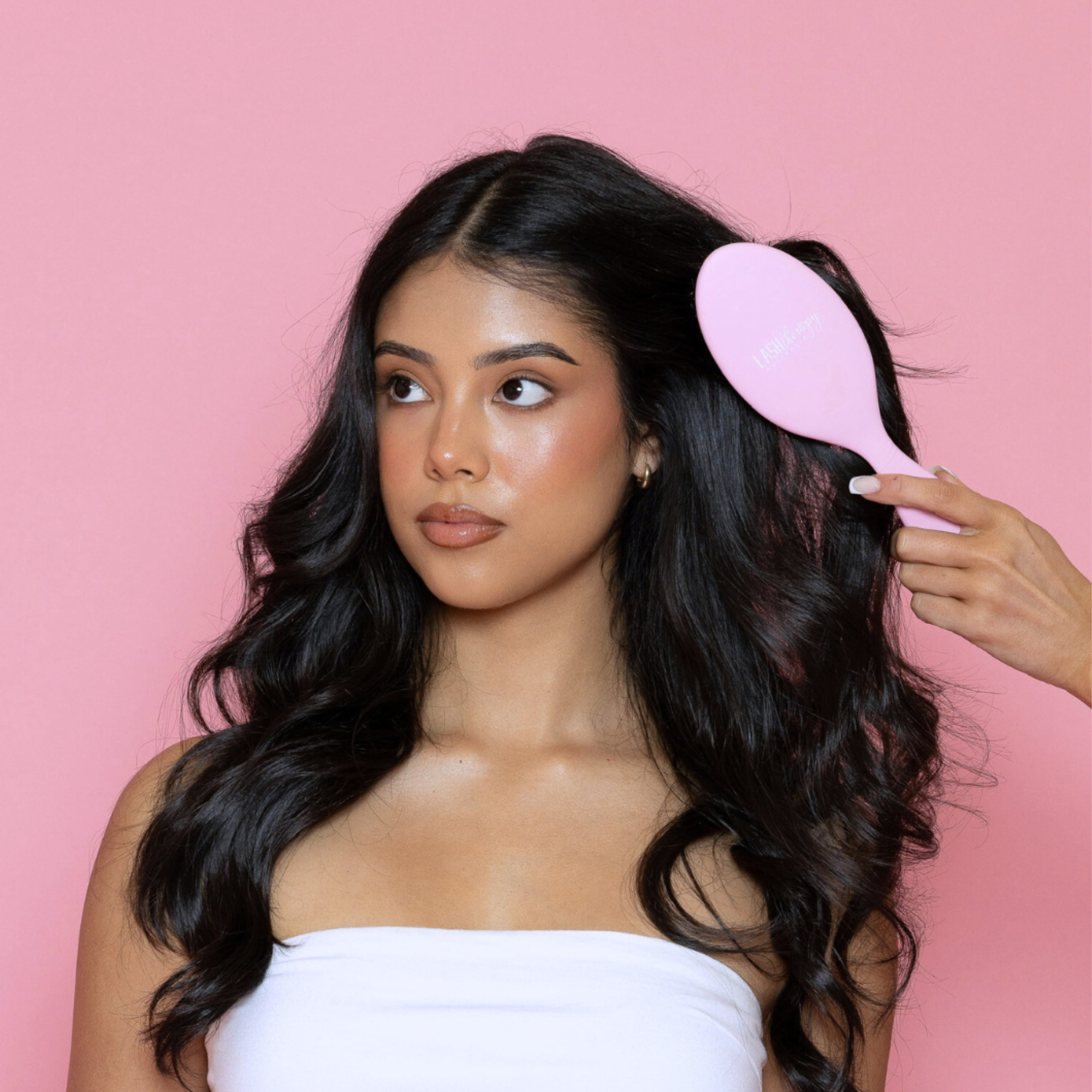 Model brushing long hair with Lash Therapy Australia detangling hair brush for smooth, healthy hair